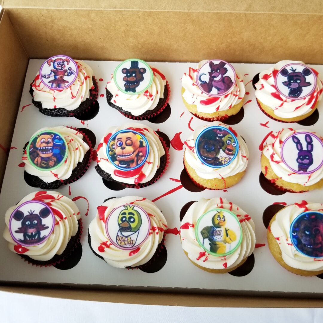 Twelve cartoon animal topping decorated Cupcakes