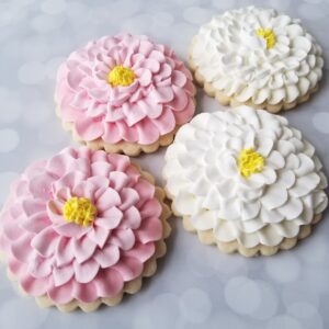 Four white and pink flower shape decorated Cookies