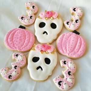 Eight pumpkin and skeleton decorated Cookies