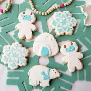Five white and sea green decorated Cookies
