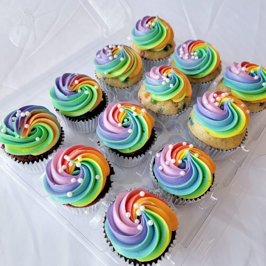 Twelve rainbow topping decorated Cupcakes