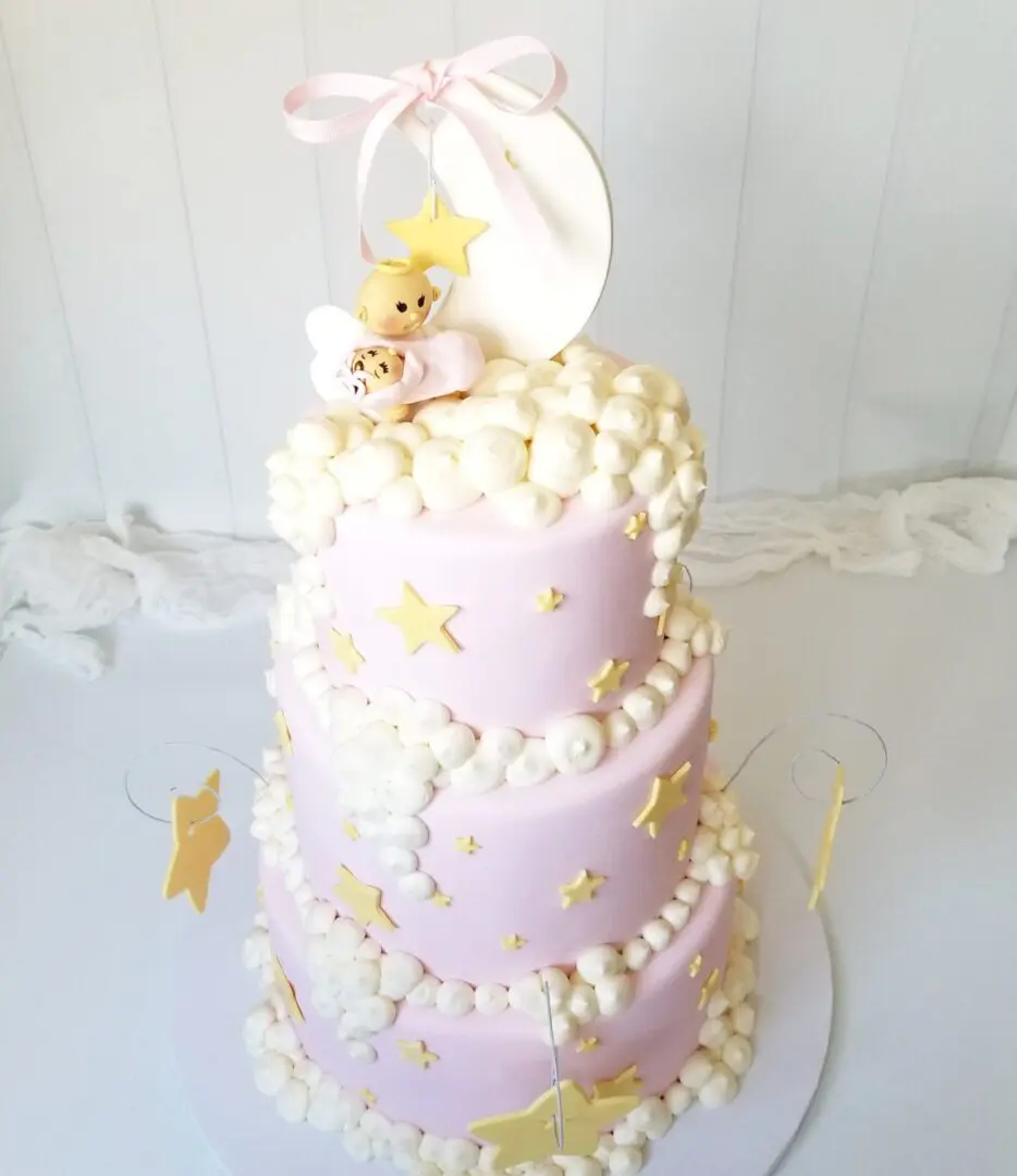 A layered cake with a moon topper