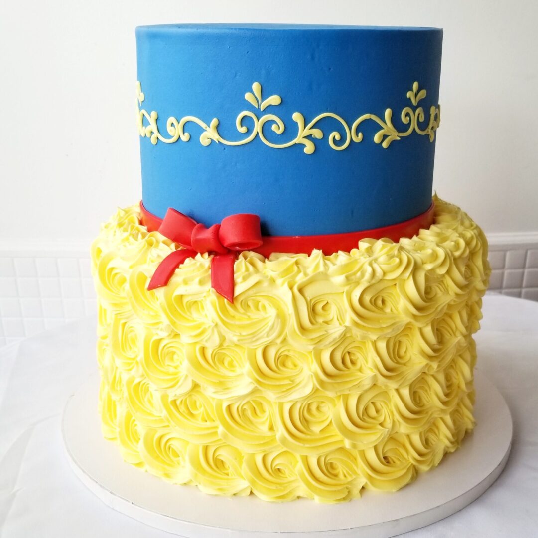 Two tier yellow and blue Girl Birthday Cake