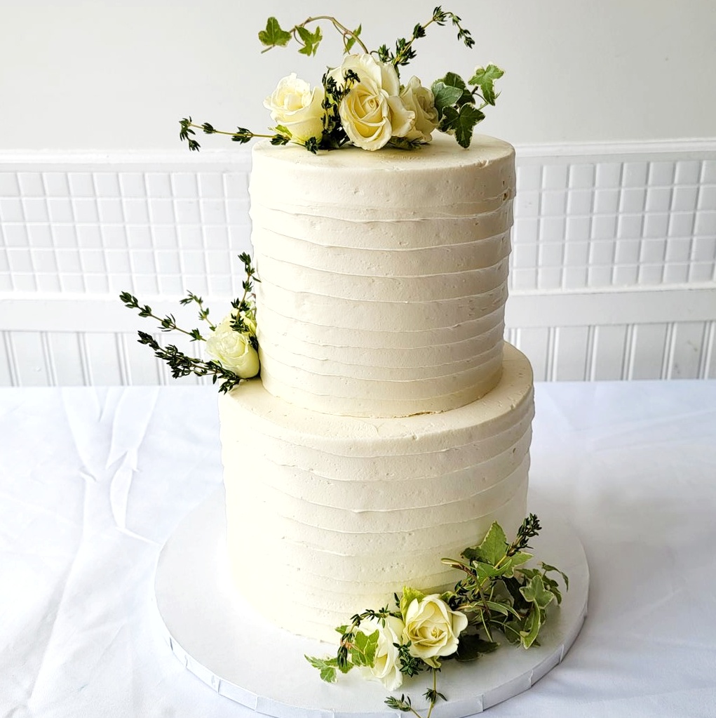 Two tier white flower decorated Wedding Cake