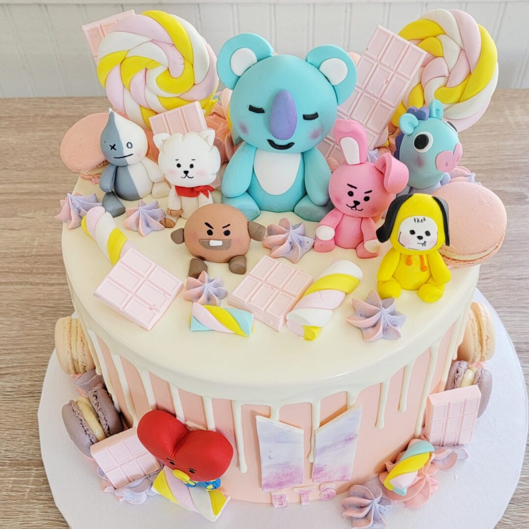 Cartoon characters with chicolates Girl Birthday Cake