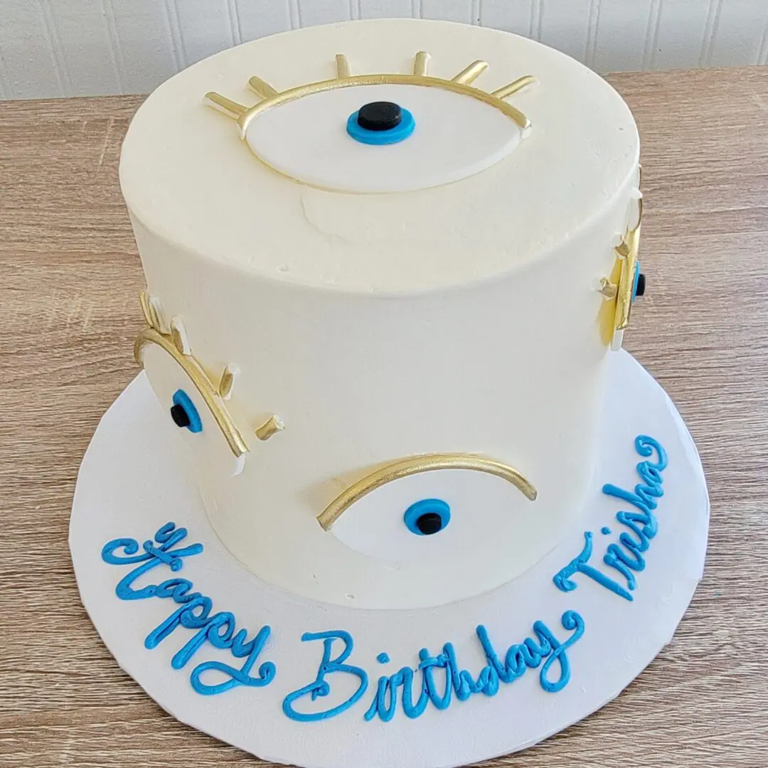 White and blue eye decorated Girl Birthday Cake