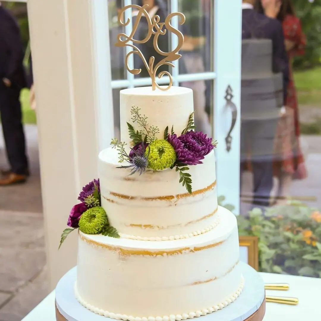 Three tier purple and green flower decorated Wedding Cake
