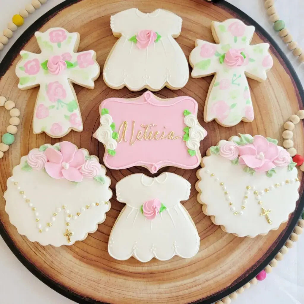 A plate of cookies with pink and white icing.