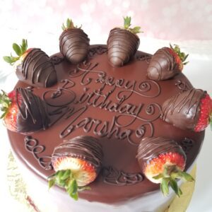 A chocolate cake with strawberries on top of it.
