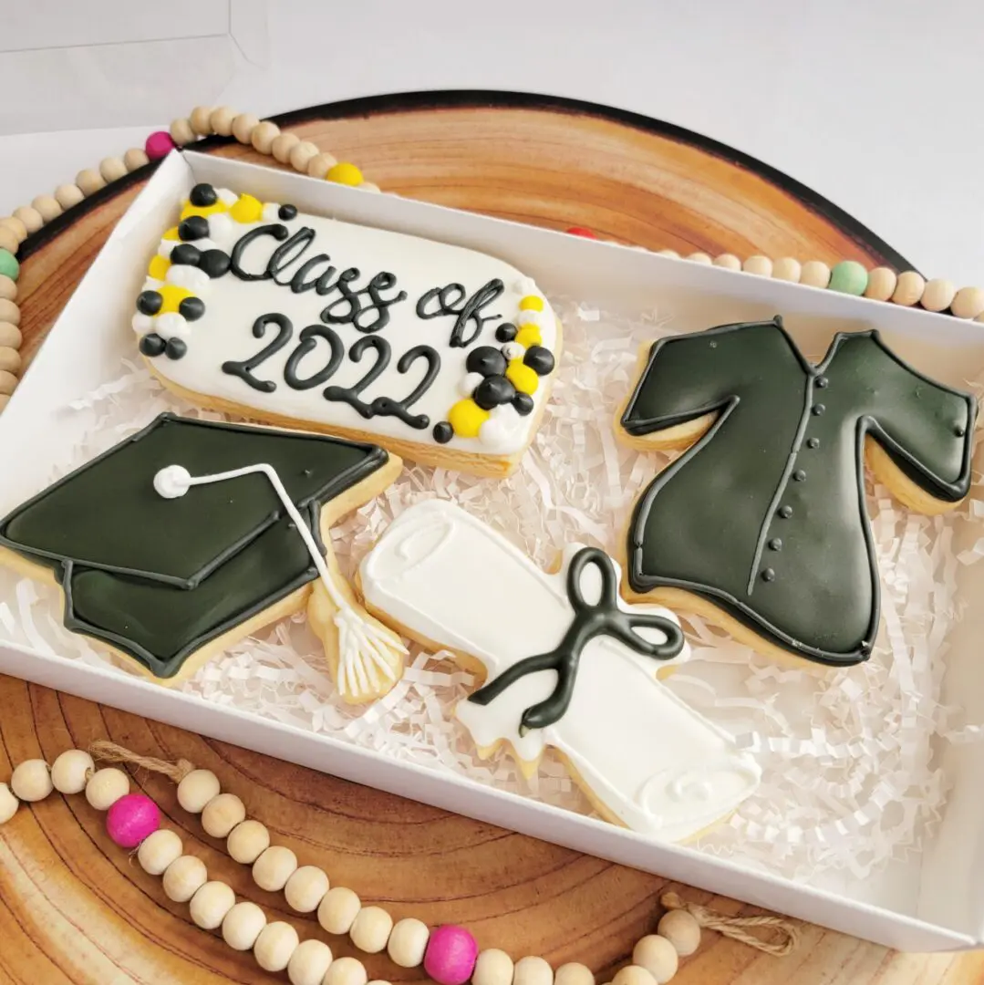 A box of graduation cookies with the class of 2 0 2 1 written on it.