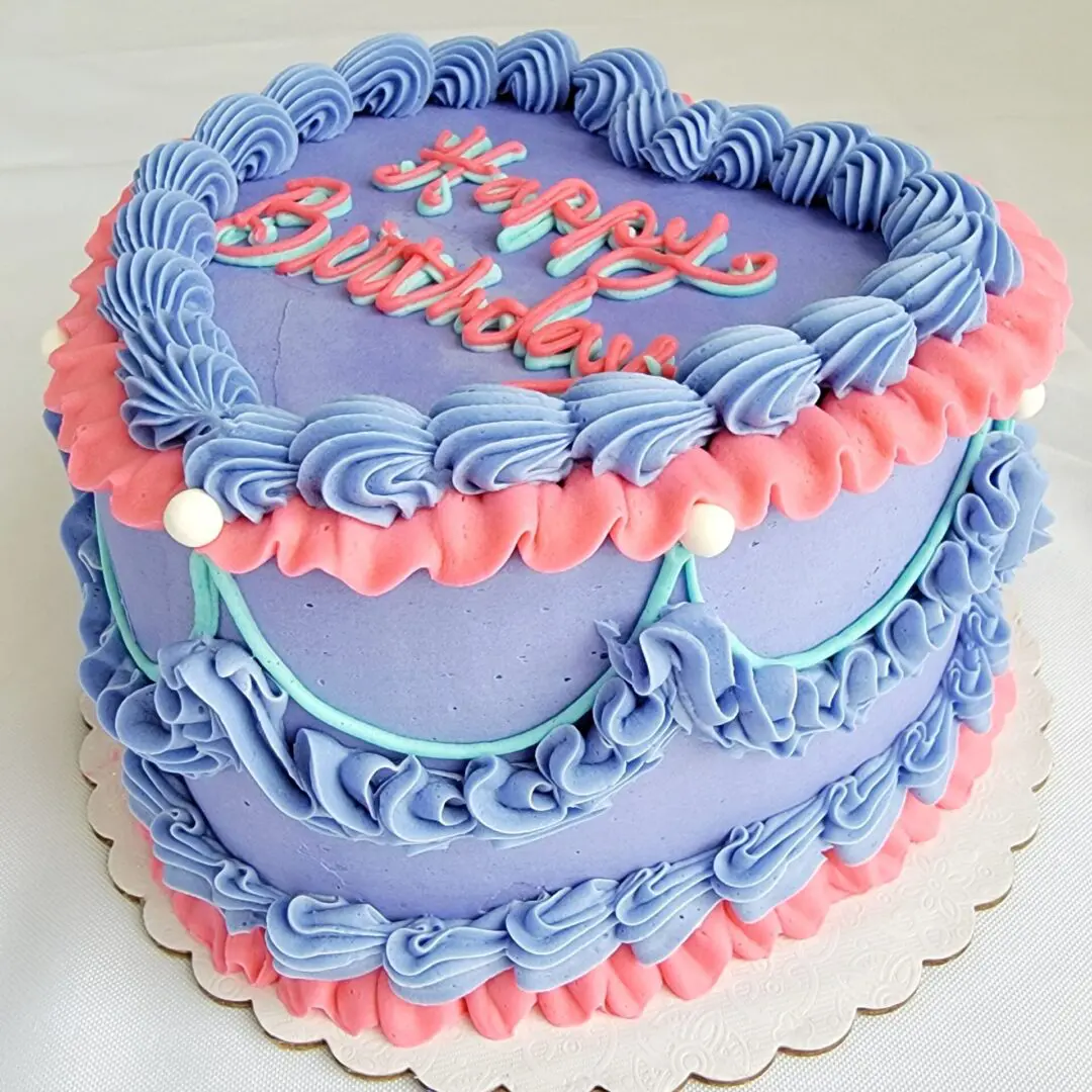 A birthday cake with blue and pink frosting.