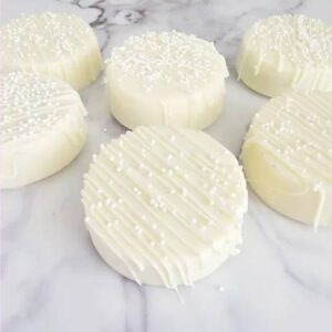 A group of six white cheese on top of a table.