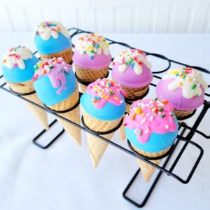 A tray of cupcakes with icing and sprinkles.