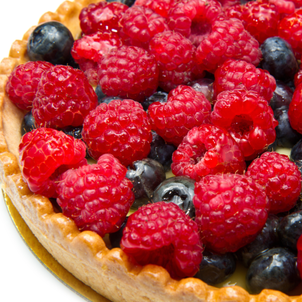 A close up of a berry topped pie